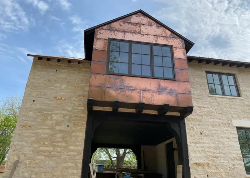 Copper metal panel facade on a stone building for Skylight Installation in Highland Village