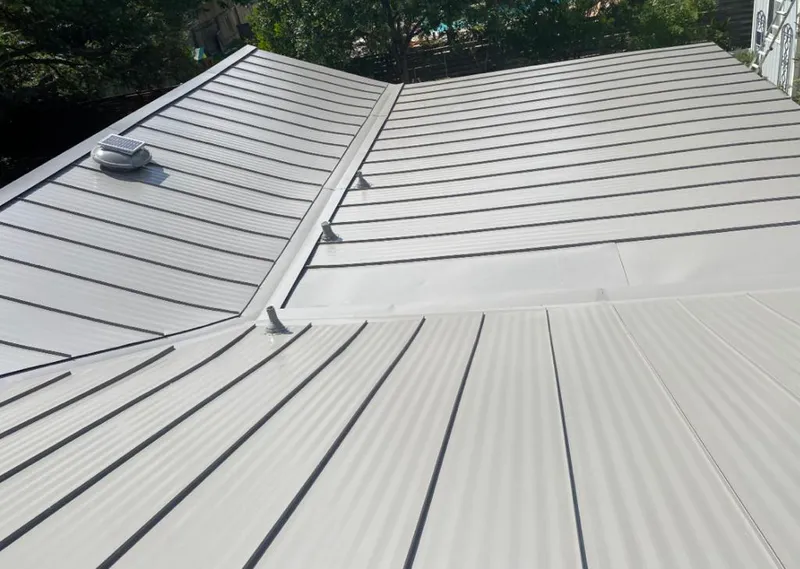 Solar attic fan installed on a metal roof for Roof Ventilation in Highland Village